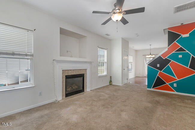 508 Summer Breeze Drive Durham, NC 27704 - Photo 6 of 28 a view of an empty room with ceiling fan and window