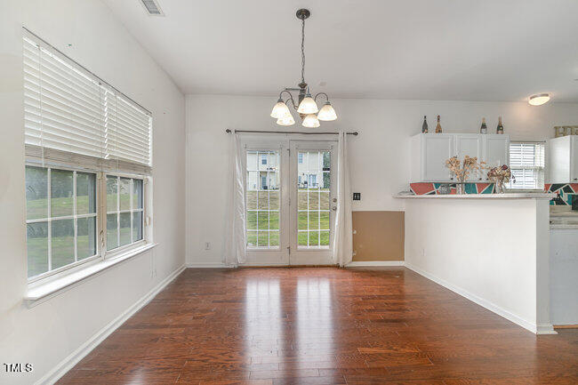 508 Summer Breeze Drive Durham, NC 27704 - Photo 8 of 28 a view of a kitchen with wooden floor and a window