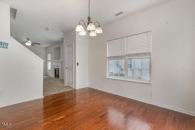 508 Summer Breeze Drive Durham, NC 27704 - Photo 9 of 28 a view of an empty room with wooden floor and a window