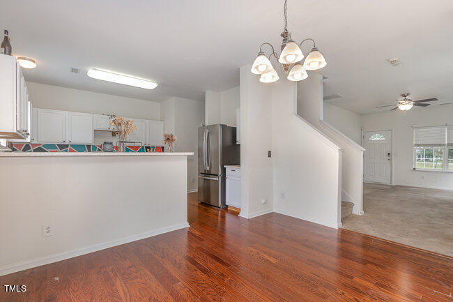 508 Summer Breeze Drive Durham, NC 27704 - Photo 10 of 28 a room with stainless steel appliances a kitchen island wooden floors and view living room