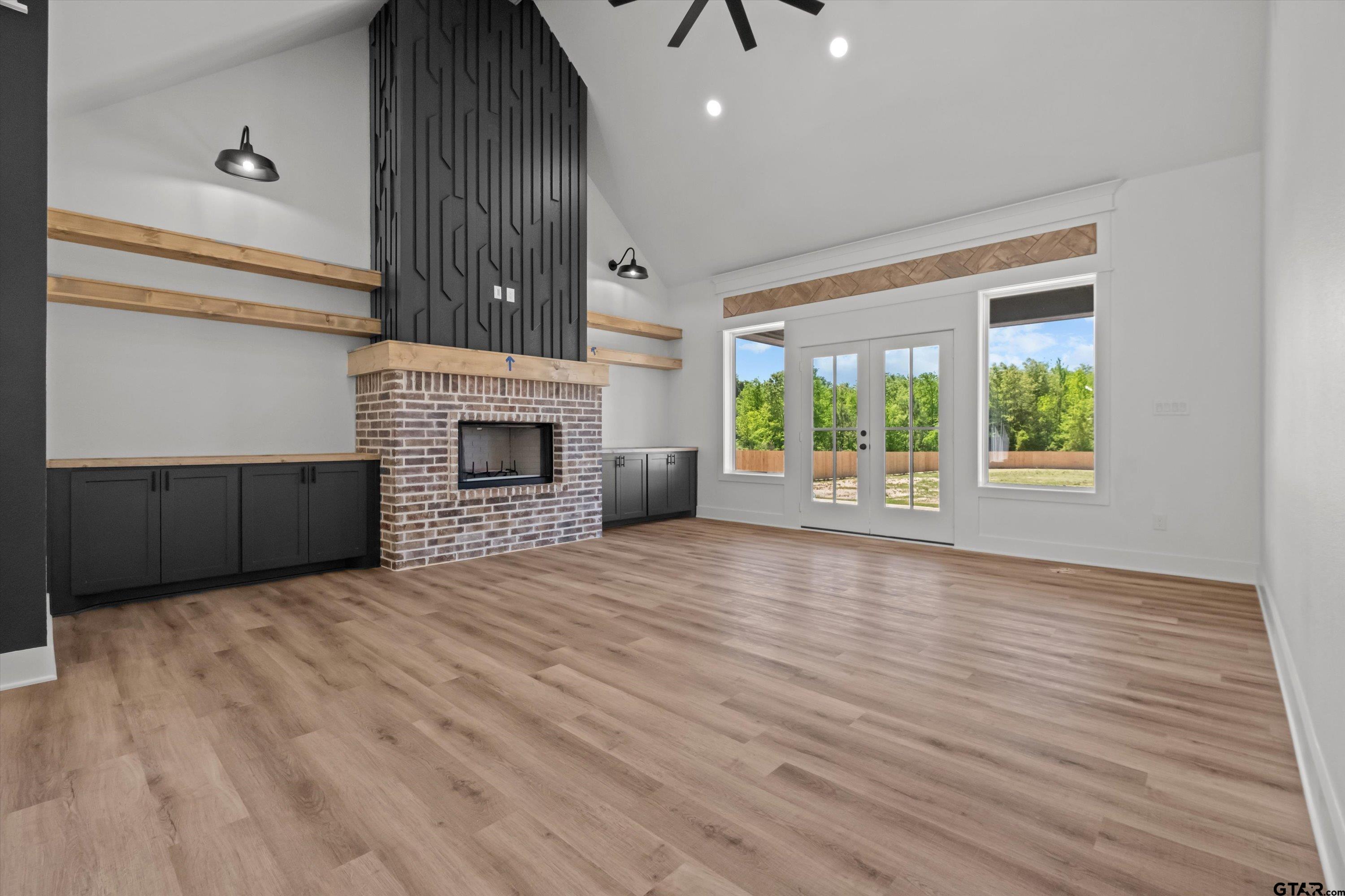 17762 Jayleen Lane Tyler, TX 75707 - Photo 11 of 24 an empty room with wooden floor fireplace and windows