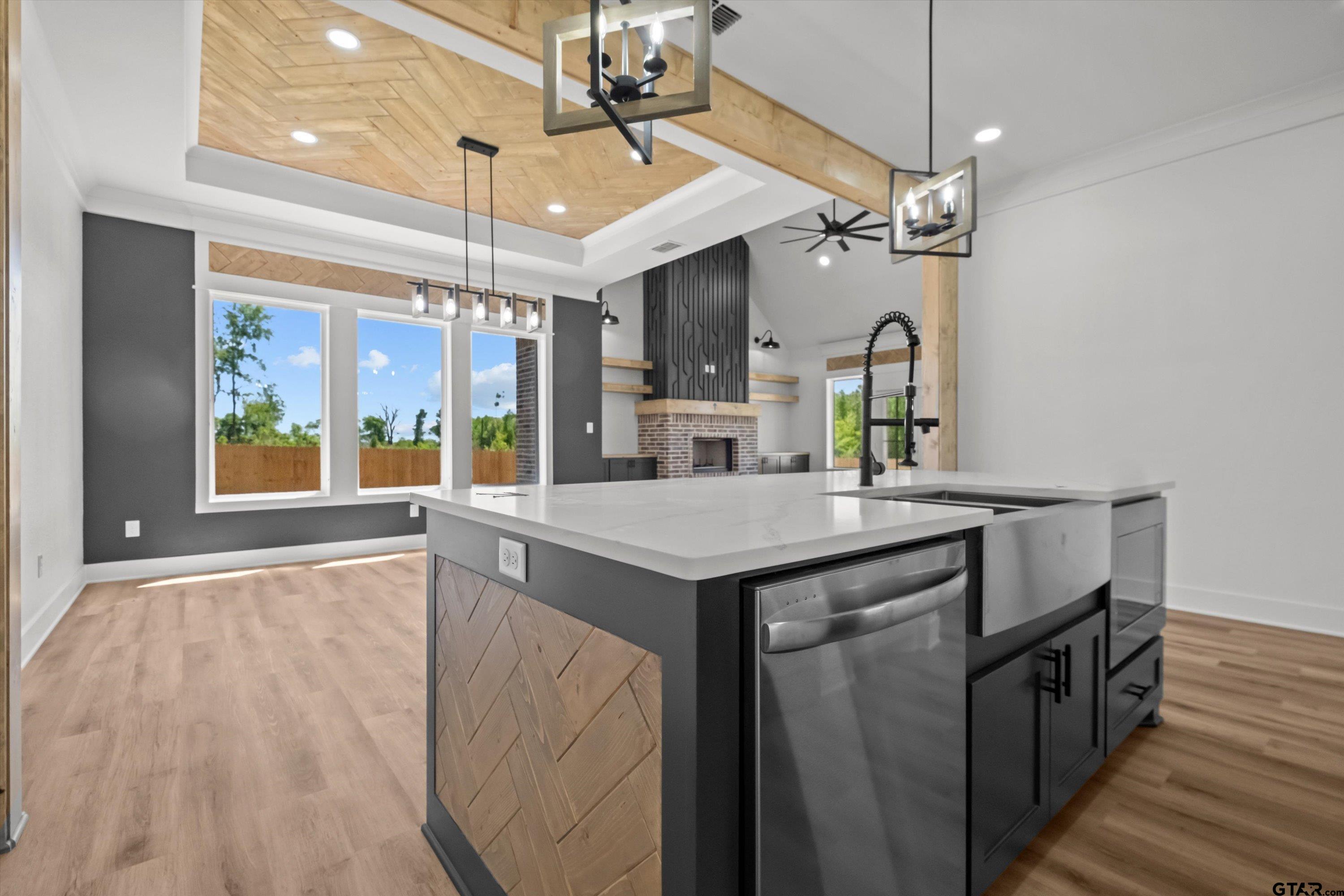 17762 Jayleen Lane Tyler, TX 75707 - Photo 15 of 24 a kitchen with kitchen island a counter top a stove and a chandelier