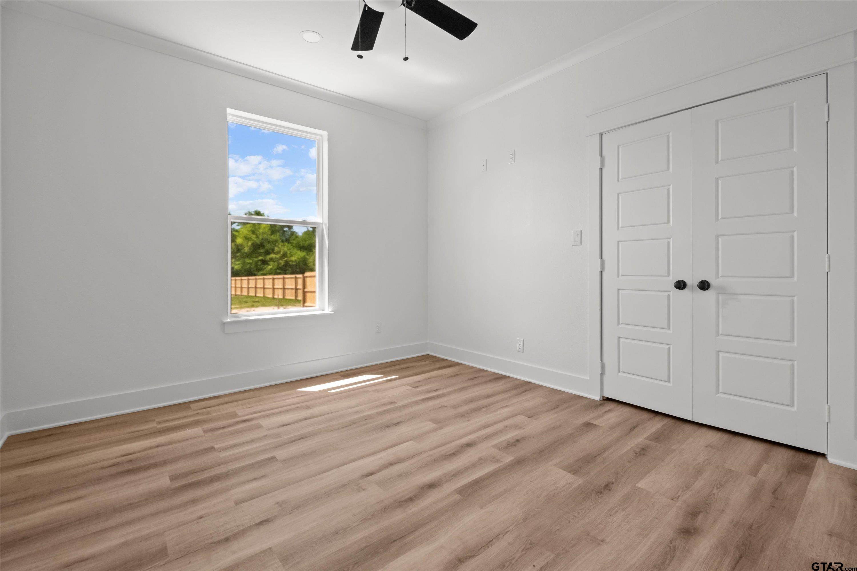 17762 Jayleen Lane Tyler, TX 75707 - Photo 18 of 24 an empty room with wooden floor cabinet and windows