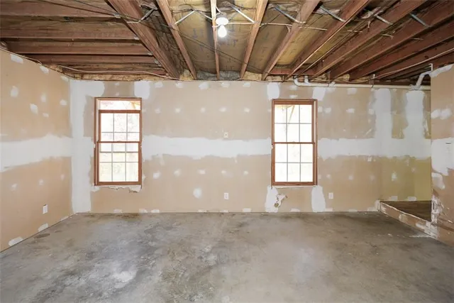 a view of a yard with snow on the tree