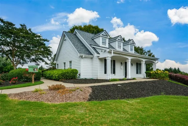 an aerial view of a house with swimming pool and sitting area