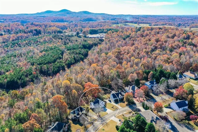 an aerial view of a house with a yard and garden