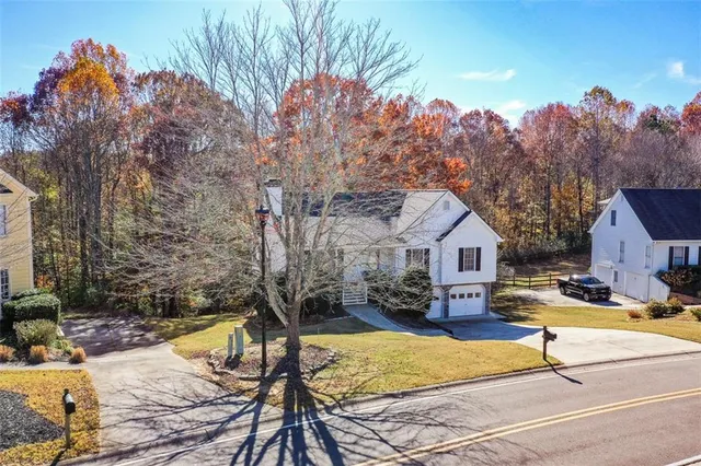 an aerial view of residential house with outdoor space and swimming pool