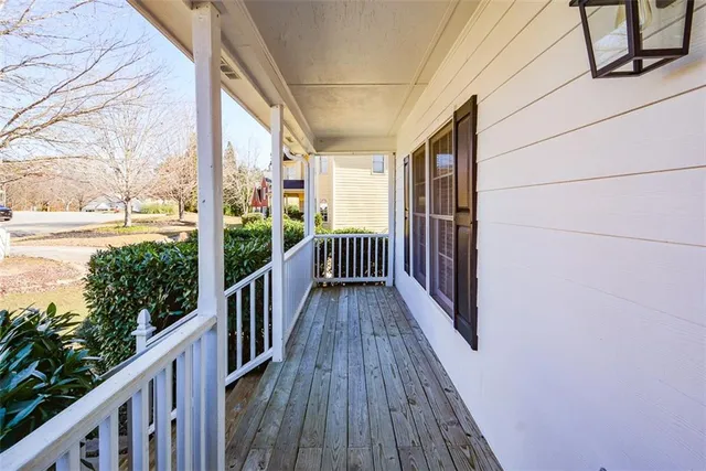 a view of empty room with wooden floor and window