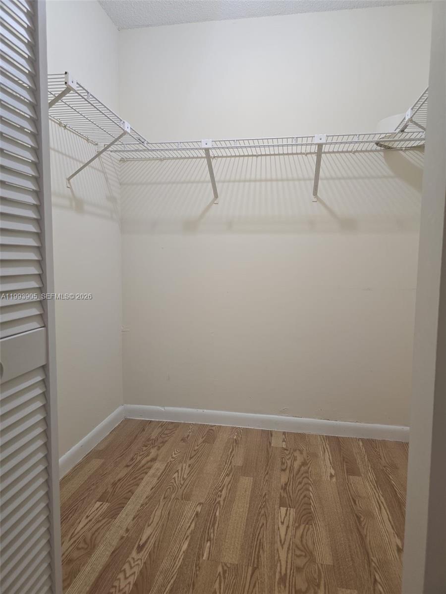 17021 North Bay Road, Unit 225 Sunny Isles Beach, FL 33160 - Photo 13 of 24 a view of a room with racks on the wall