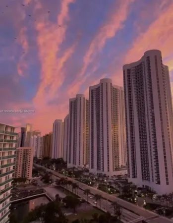 a view of a building with garden space and street view