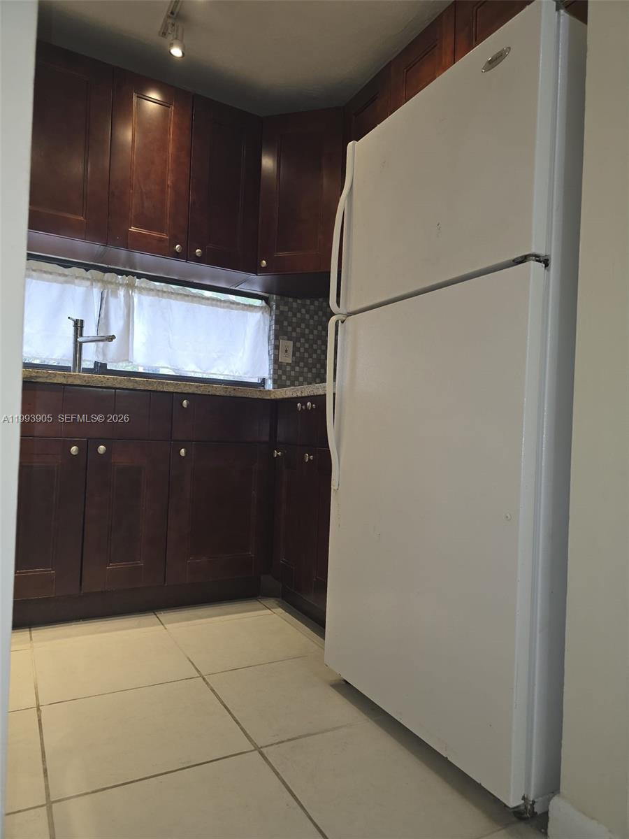 17021 North Bay Road, Unit 225 Sunny Isles Beach, FL 33160 - Photo 7 of 24 a kitchen with a refrigerator and a sink