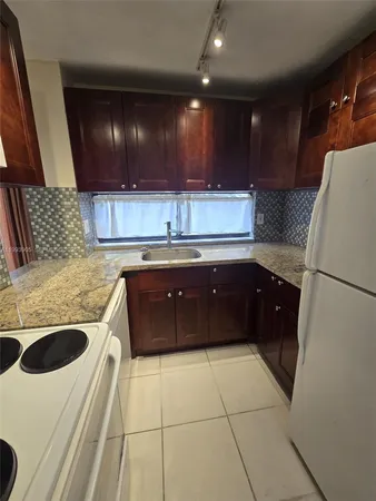 a kitchen with a sink and a refrigerator
