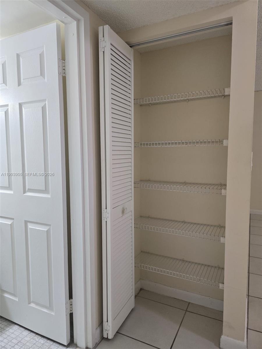 17021 North Bay Road, Unit 225 Sunny Isles Beach, FL 33160 - Photo 9 of 24 a view of walk in closet with empty racks