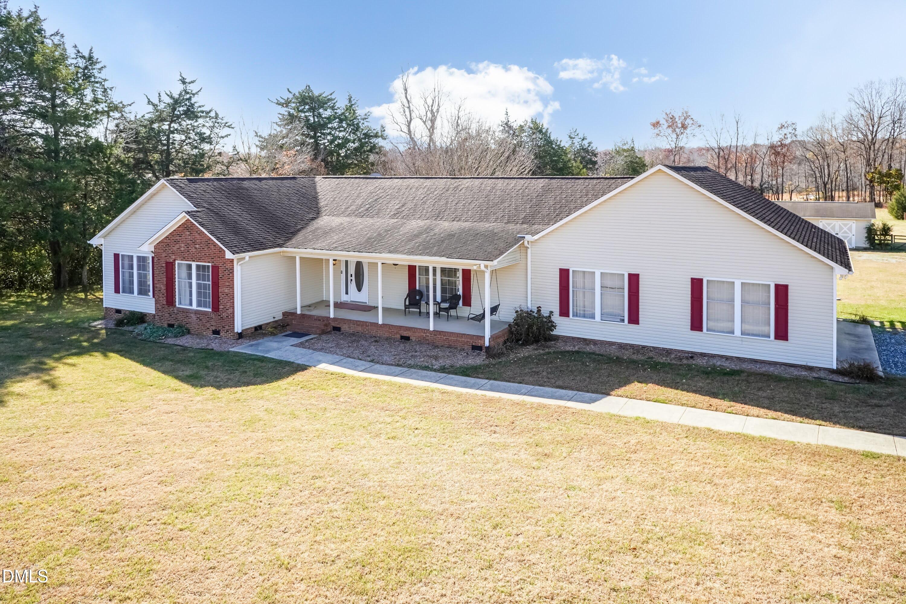 1722 Saddle Club Road Mebane, NC 27302 - Photo 1 of 37 a front view of a house with swimming pool