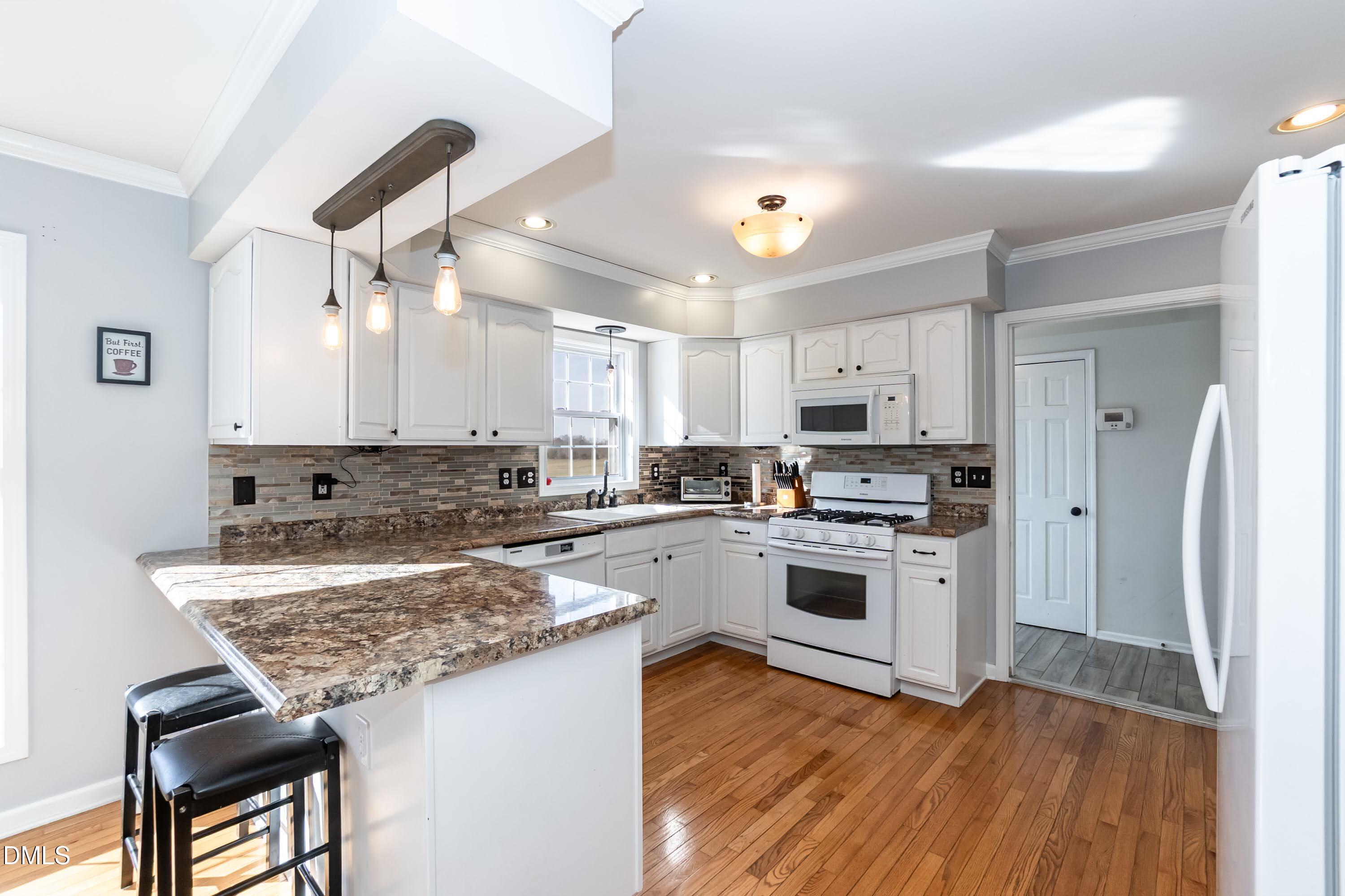 1722 Saddle Club Road Mebane, NC 27302 - Photo 11 of 37 a kitchen with a stove cabinets and a refrigerator