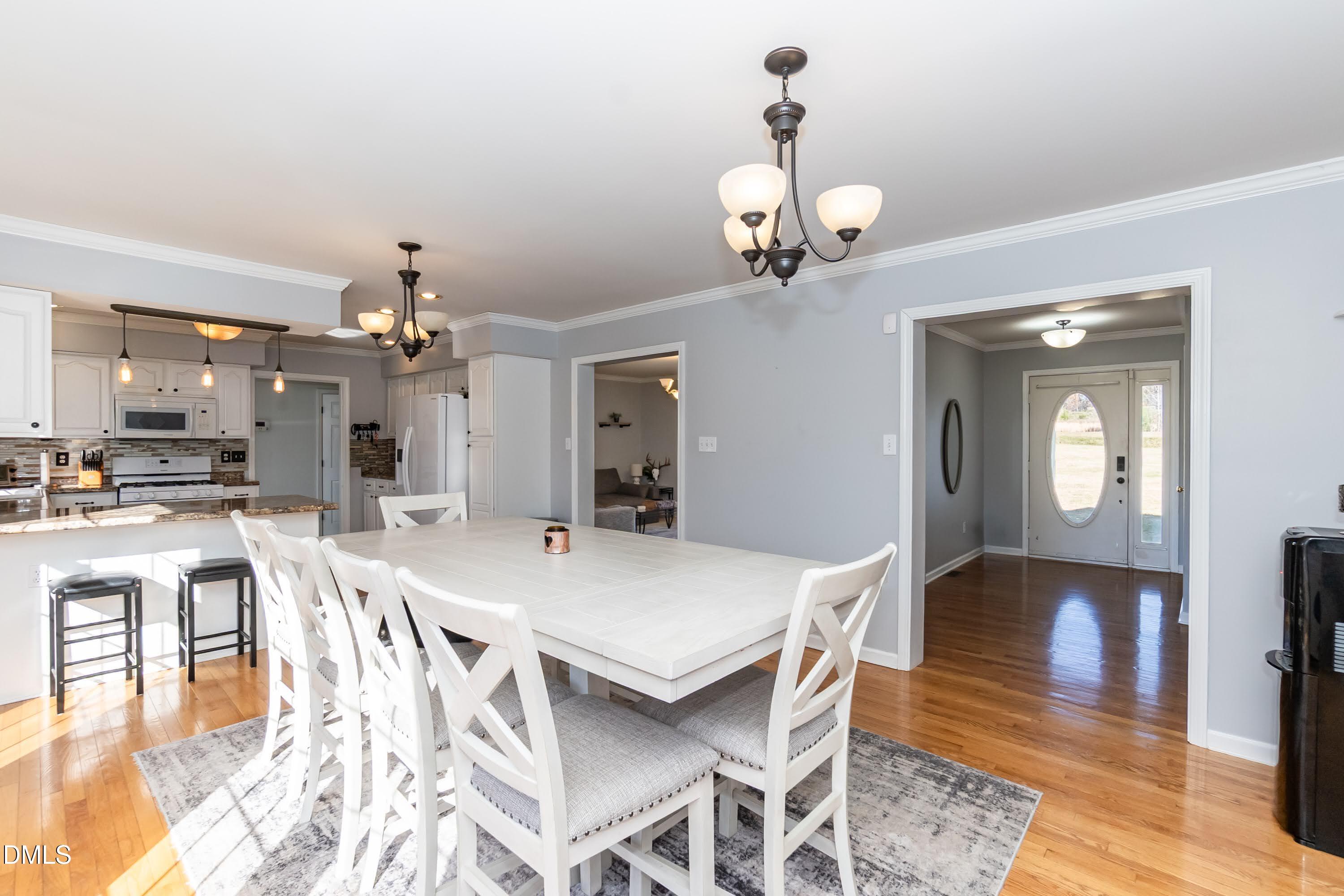 1722 Saddle Club Road Mebane, NC 27302 - Photo 15 of 37 a view of a dining room with furniture and wooden floor