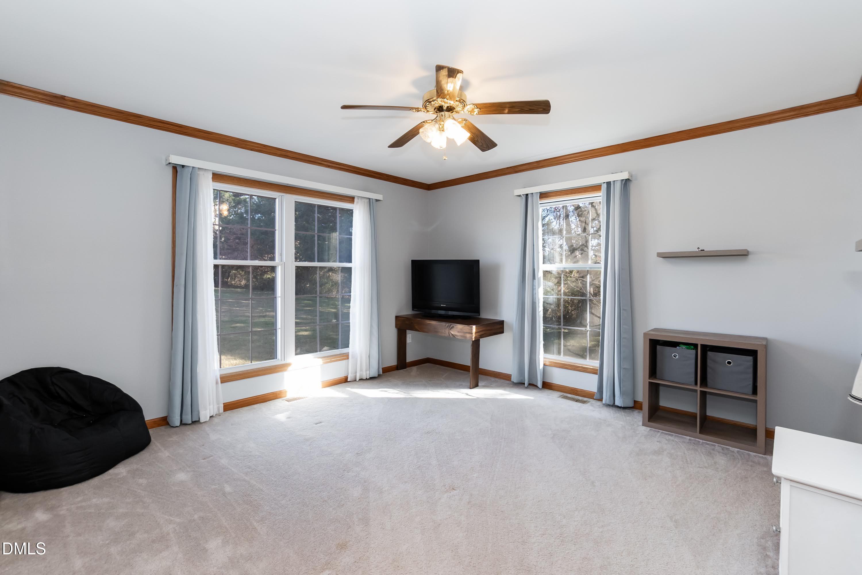 1722 Saddle Club Road Mebane, NC 27302 - Photo 24 of 37 a living room with furniture and a flat screen tv