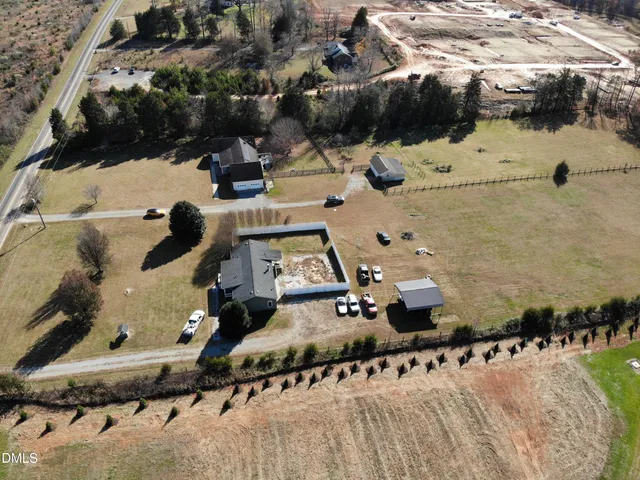 an aerial view of a houses with yard