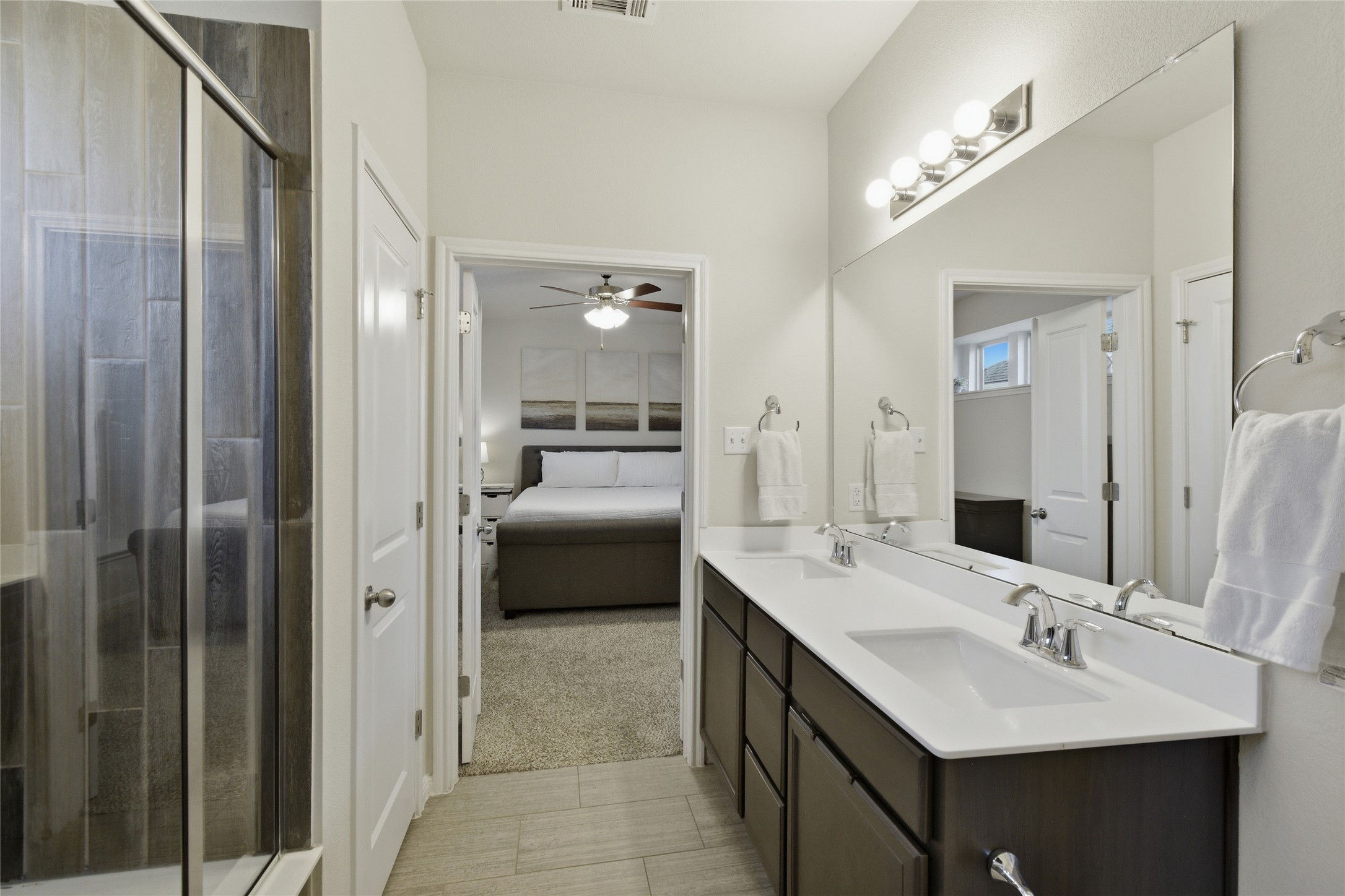8152 Daisy Cutter Crossing Georgetown, TX 78626 - Photo 11 of 23 a en suite bathroom with a double vanity sink and mirror