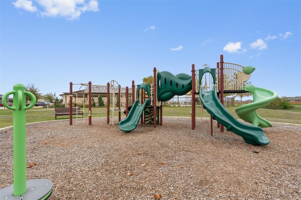 8152 Daisy Cutter Crossing Georgetown, TX 78626 - Photo 22 of 23 a park with lots of swings and slides