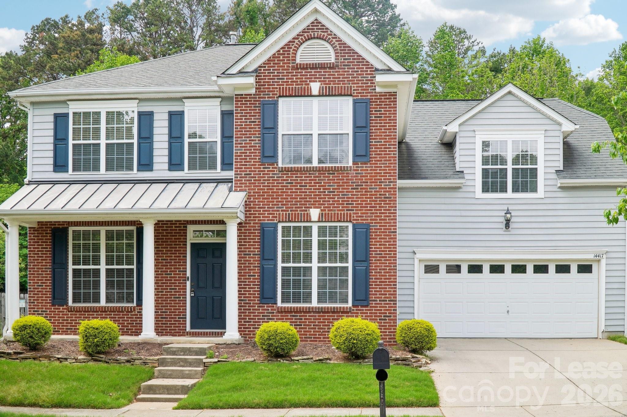 14417 Laurel Tree Lane Huntersville, NC 28078 - Photo 1 of 48 a front view of a house with garden