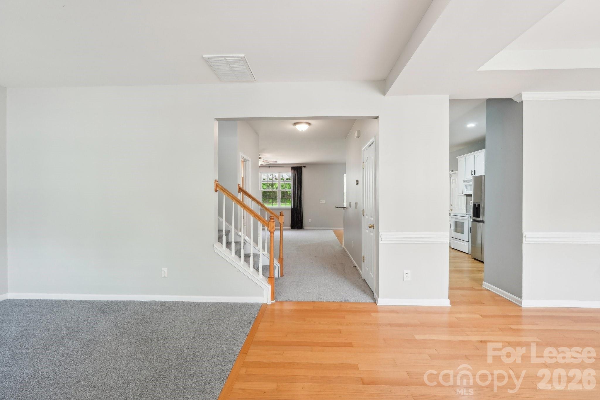 14417 Laurel Tree Lane Huntersville, NC 28078 - Photo 15 of 48 a view of a hallway with wooden floor and staircase
