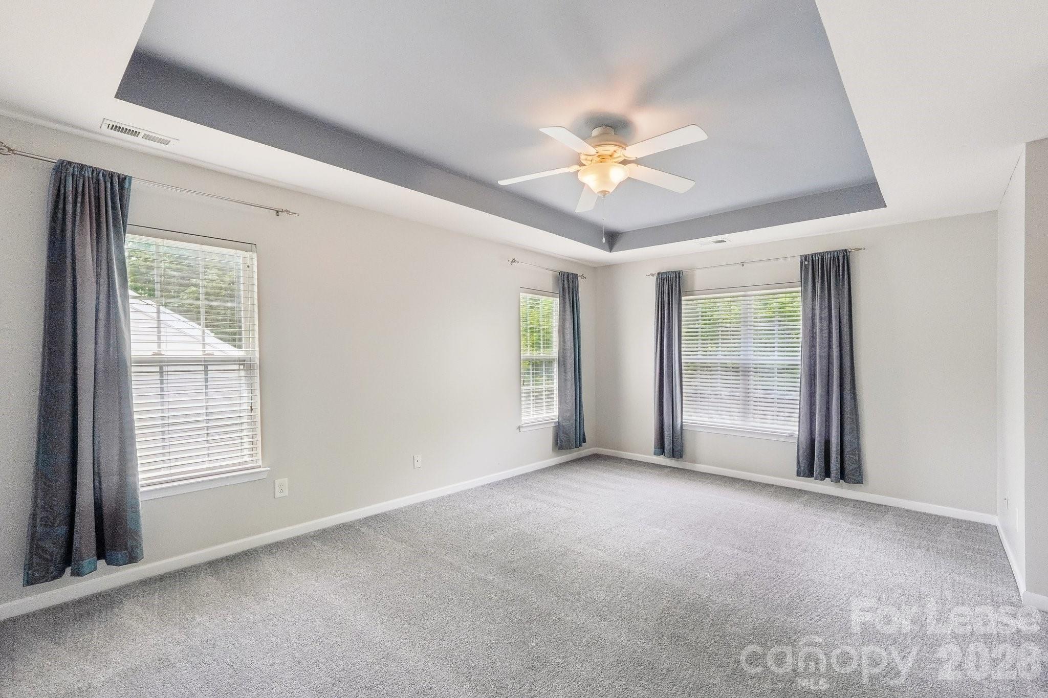 14417 Laurel Tree Lane Huntersville, NC 28078 - Photo 24 of 48 a view of an empty room with chandelier fan and fire place