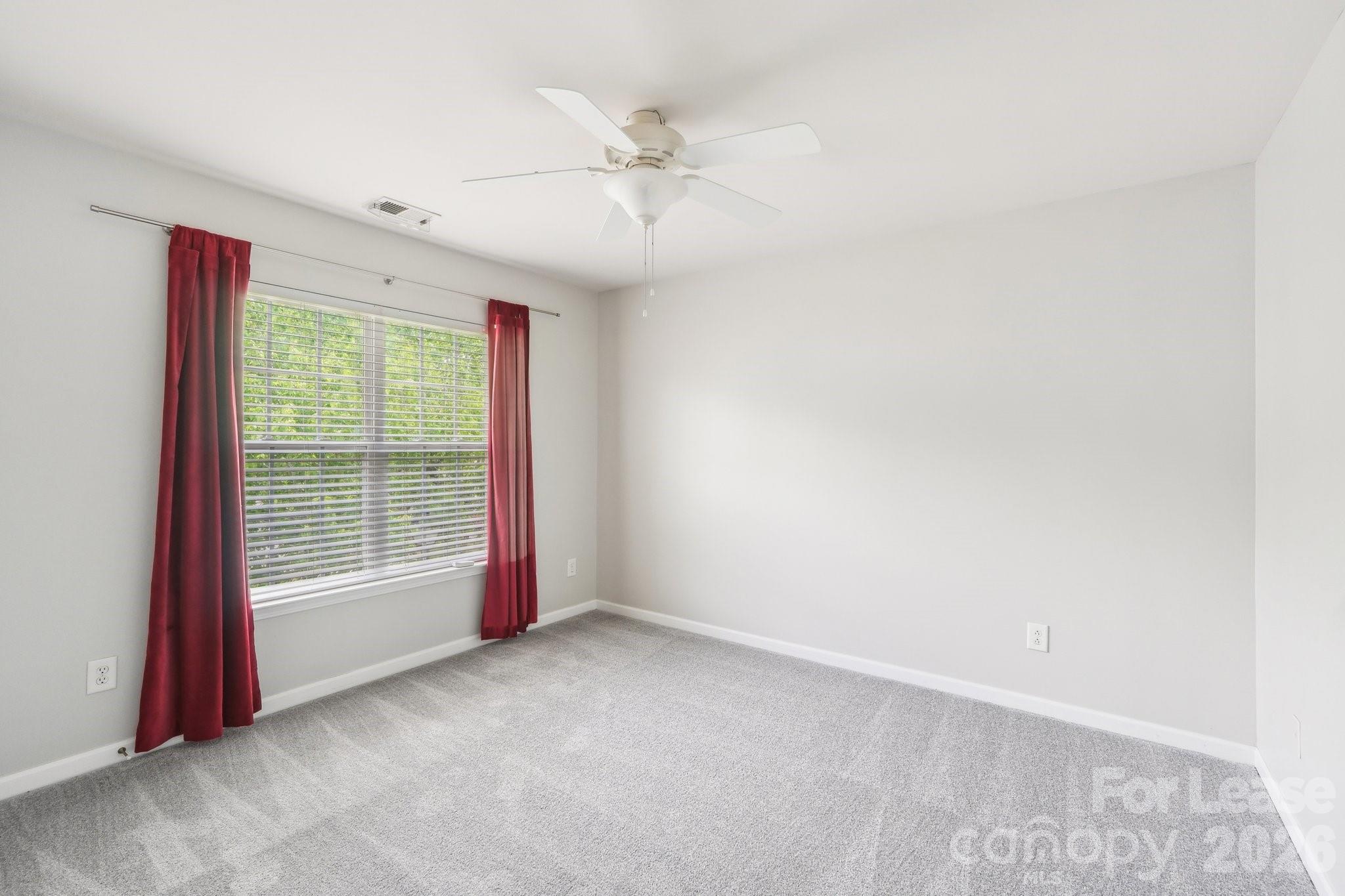 14417 Laurel Tree Lane Huntersville, NC 28078 - Photo 28 of 48 an empty room with windows and fan