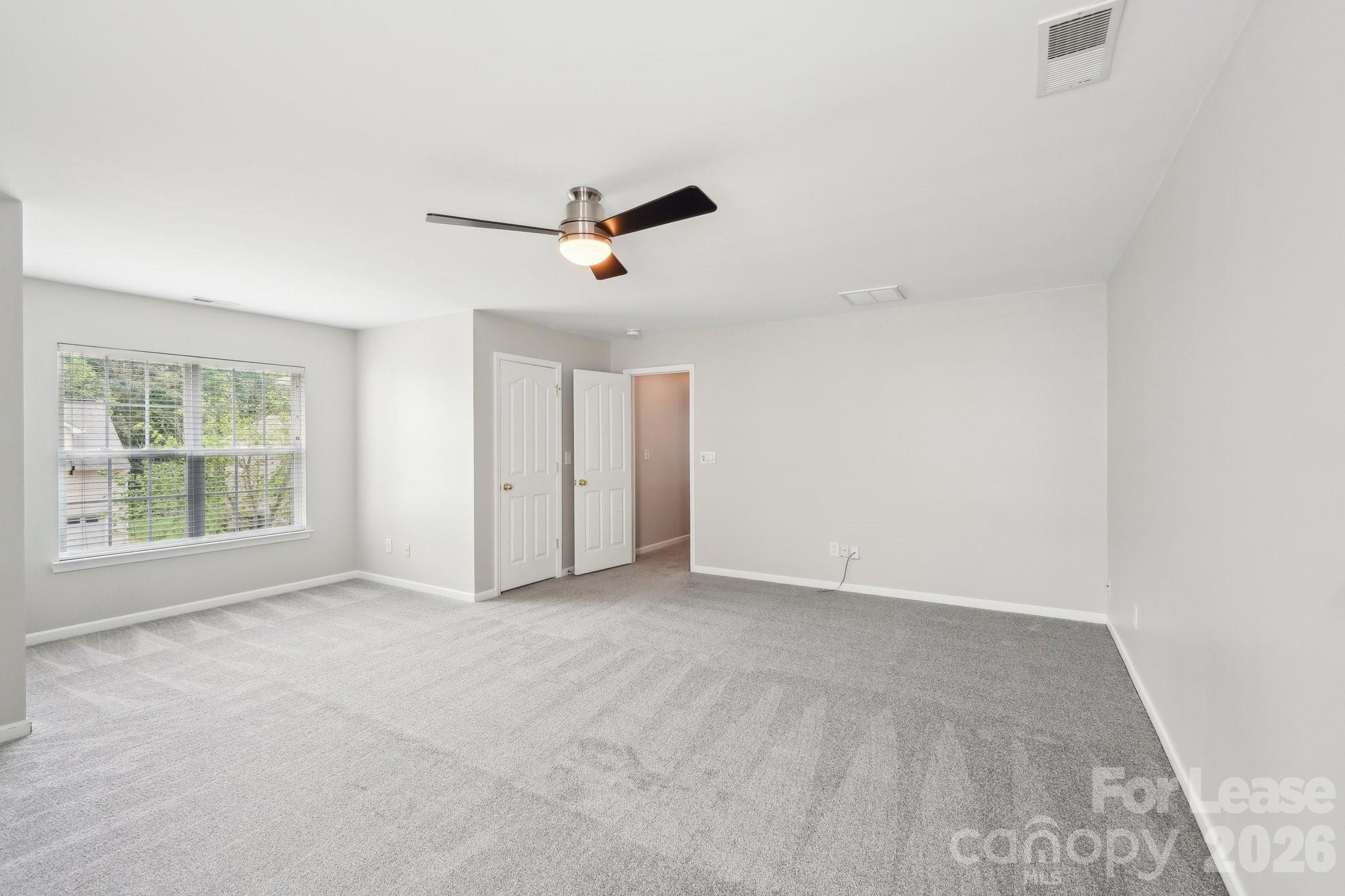 14417 Laurel Tree Lane Huntersville, NC 28078 - Photo 35 of 48 an empty room with a empty space and windows