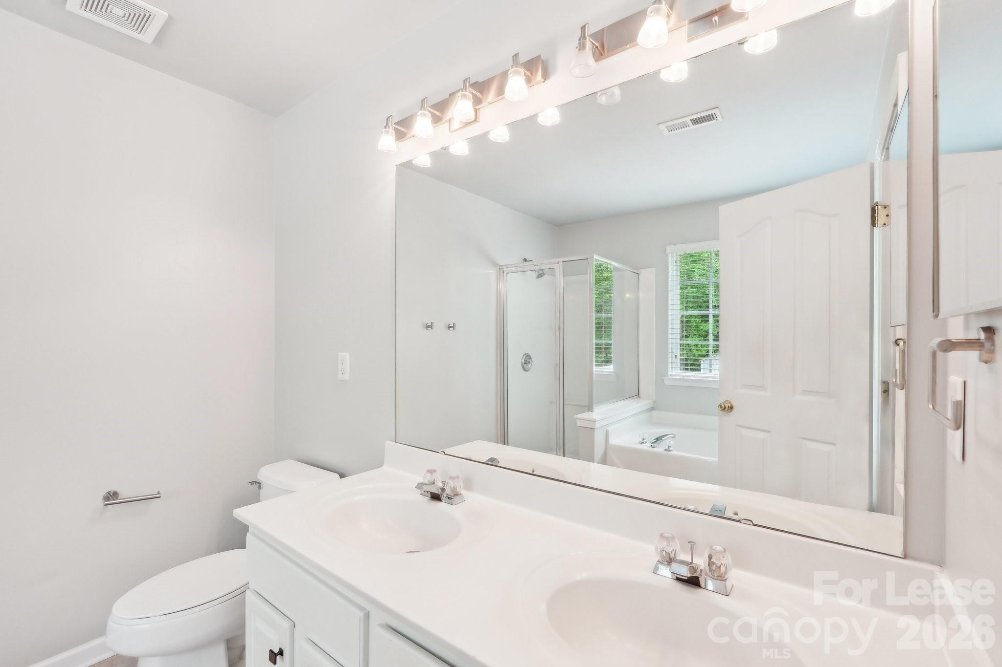 14417 Laurel Tree Lane Huntersville, NC 28078 - Photo 41 of 48 a bathroom with a tub a sink and mirror