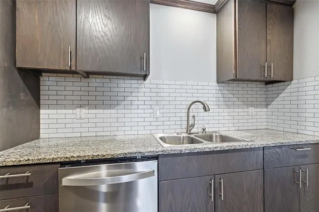 a kitchen with granite countertop cabinets and sink