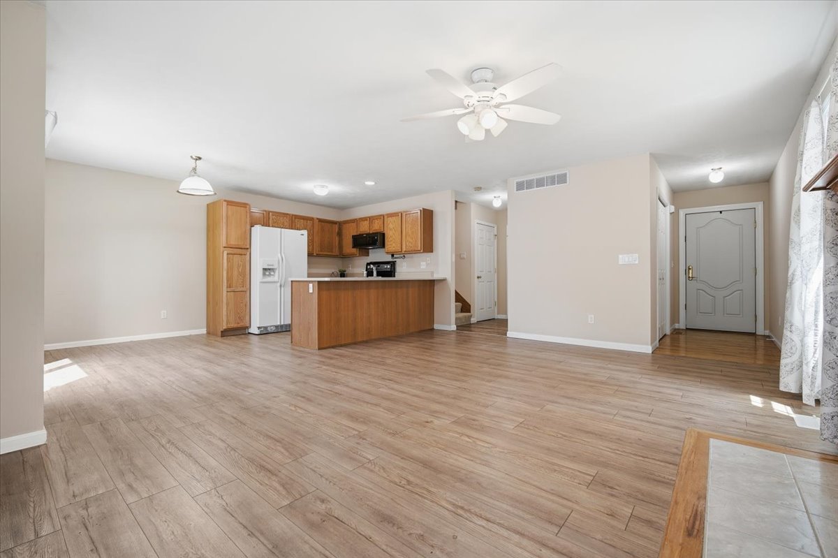 311 Old Farm Road Bloomington, IL 61704 - Photo 9 of 34 a view of a kitchen with a sink and a refrigerator
