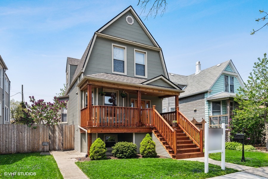 4340 North Harding Avenue Chicago, IL 60618 - Photo 1 of 14 a front view of a house with a yard and potted plants
