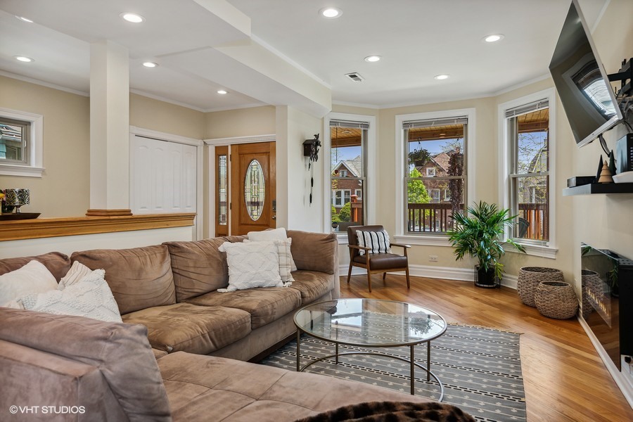 4340 North Harding Avenue Chicago, IL 60618 - Photo 2 of 14 a living room with furniture or couch and a flat screen tv