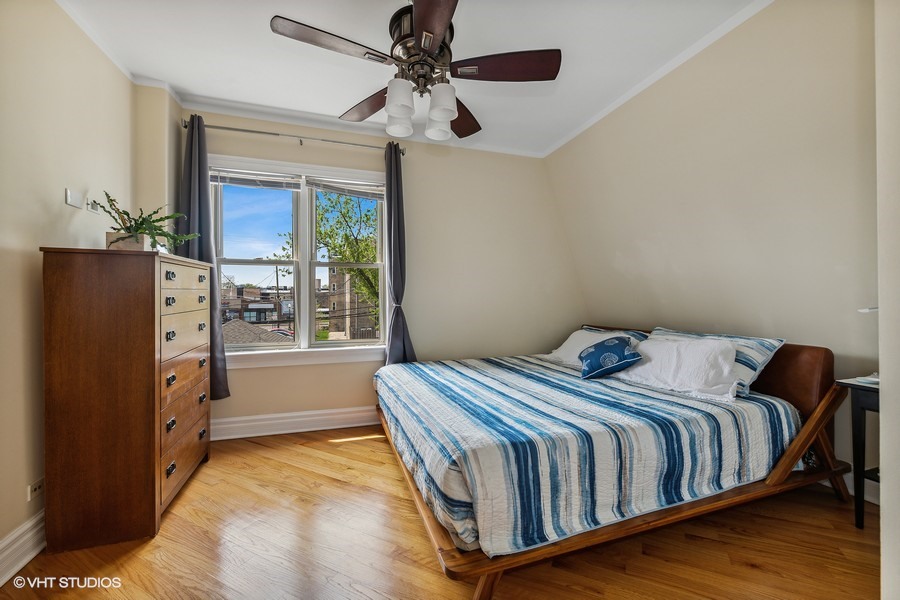 4340 North Harding Avenue Chicago, IL 60618 - Photo 7 of 14 a bed sitting in a bedroom next to a window