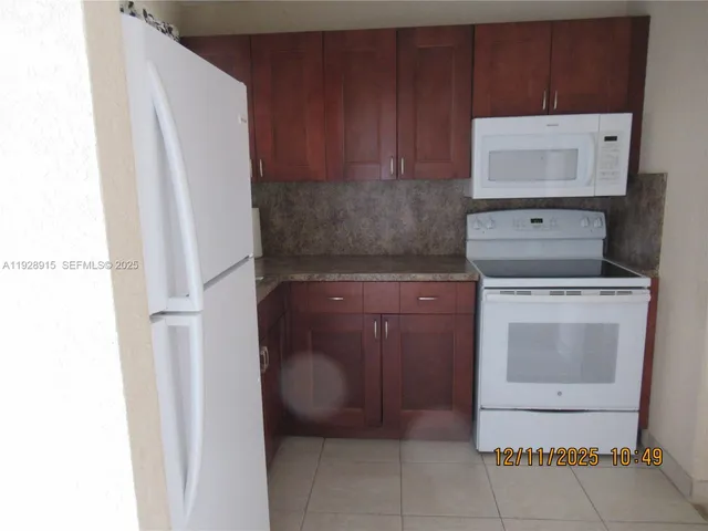 a stove top oven sitting inside of a kitchen