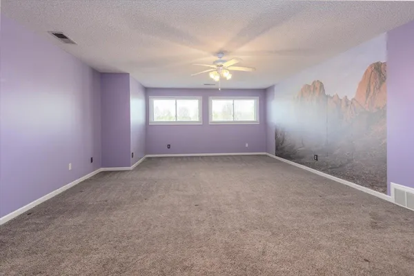 a house view with swimming pool and trees in the background