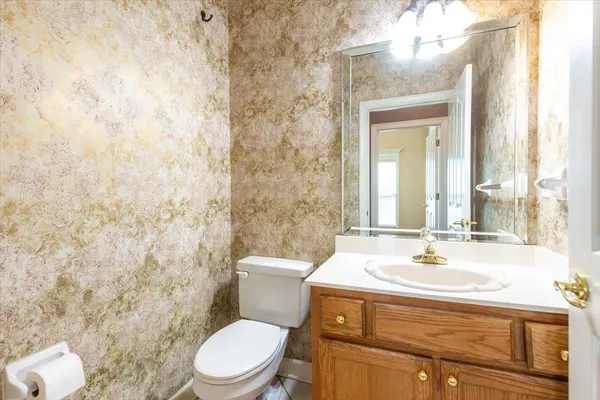 a view of an empty room with a fireplace and a window