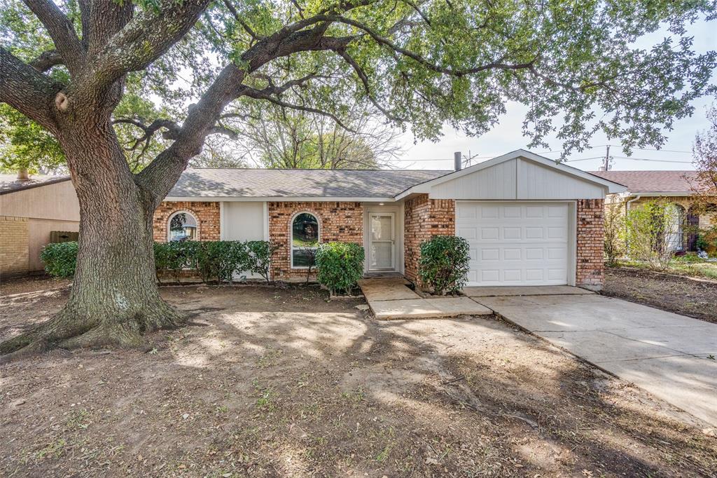 a view of a house with a tree in front