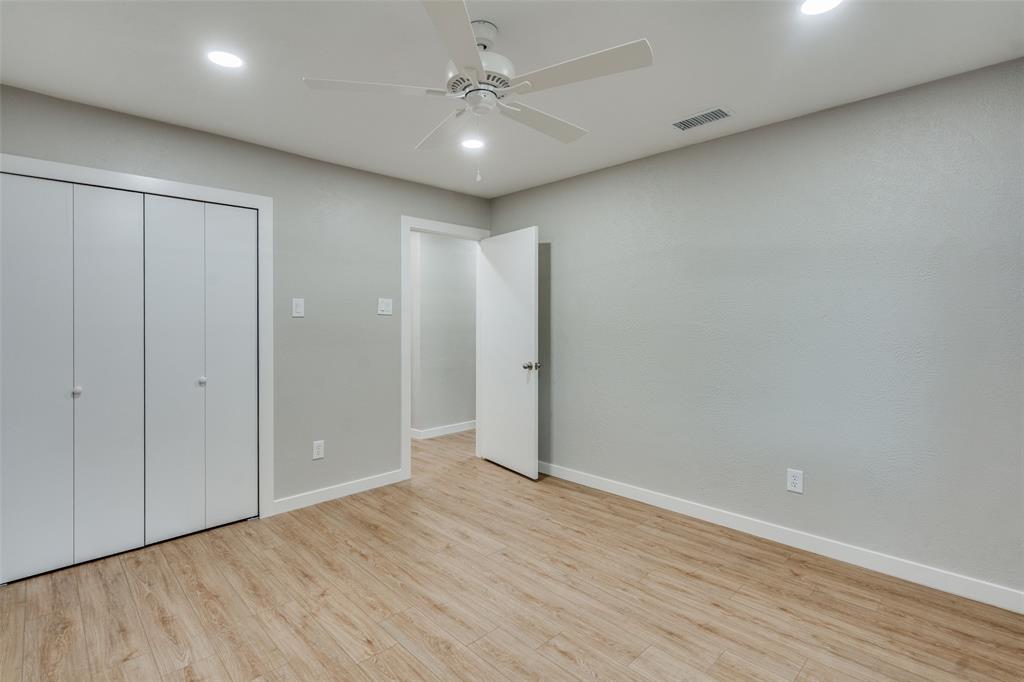 516 Ridgemont Drive Allen, TX 75002 - Photo 15 of 25 an empty room with wooden floor and fan