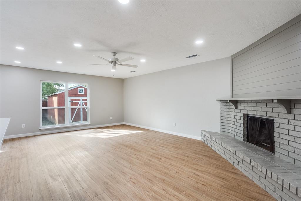 516 Ridgemont Drive Allen, TX 75002 - Photo 10 of 25 an empty room with windows and fireplace