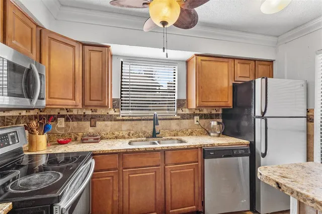a kitchen with stainless steel appliances granite countertop a sink stove and refrigerator