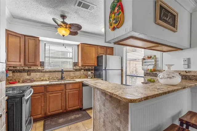a kitchen with stainless steel appliances granite countertop a sink and a window