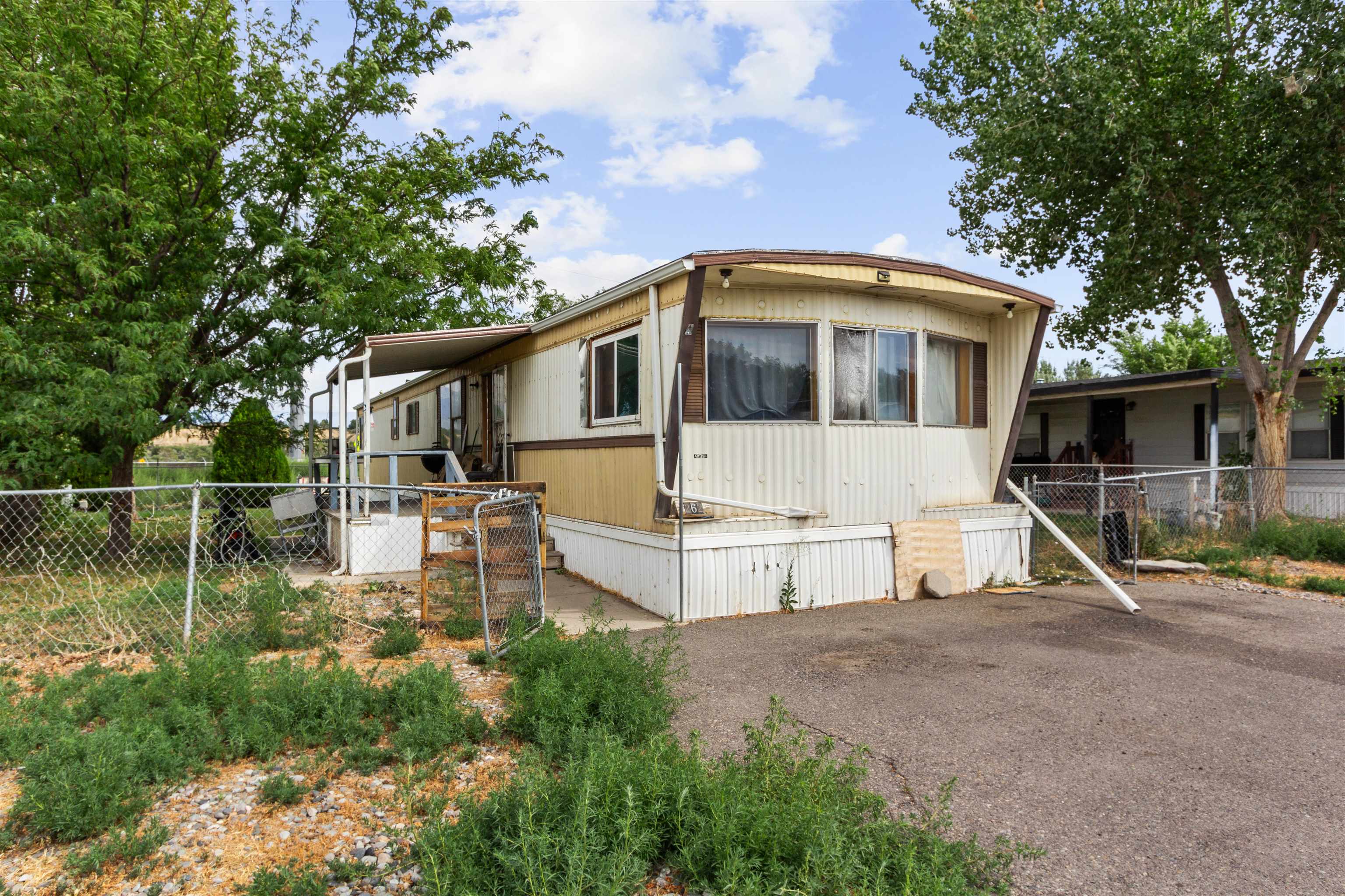 424 32 Road, Unit 262 Clifton, CO 81520 - Photo 1 of 16 a front view of a house with a yard