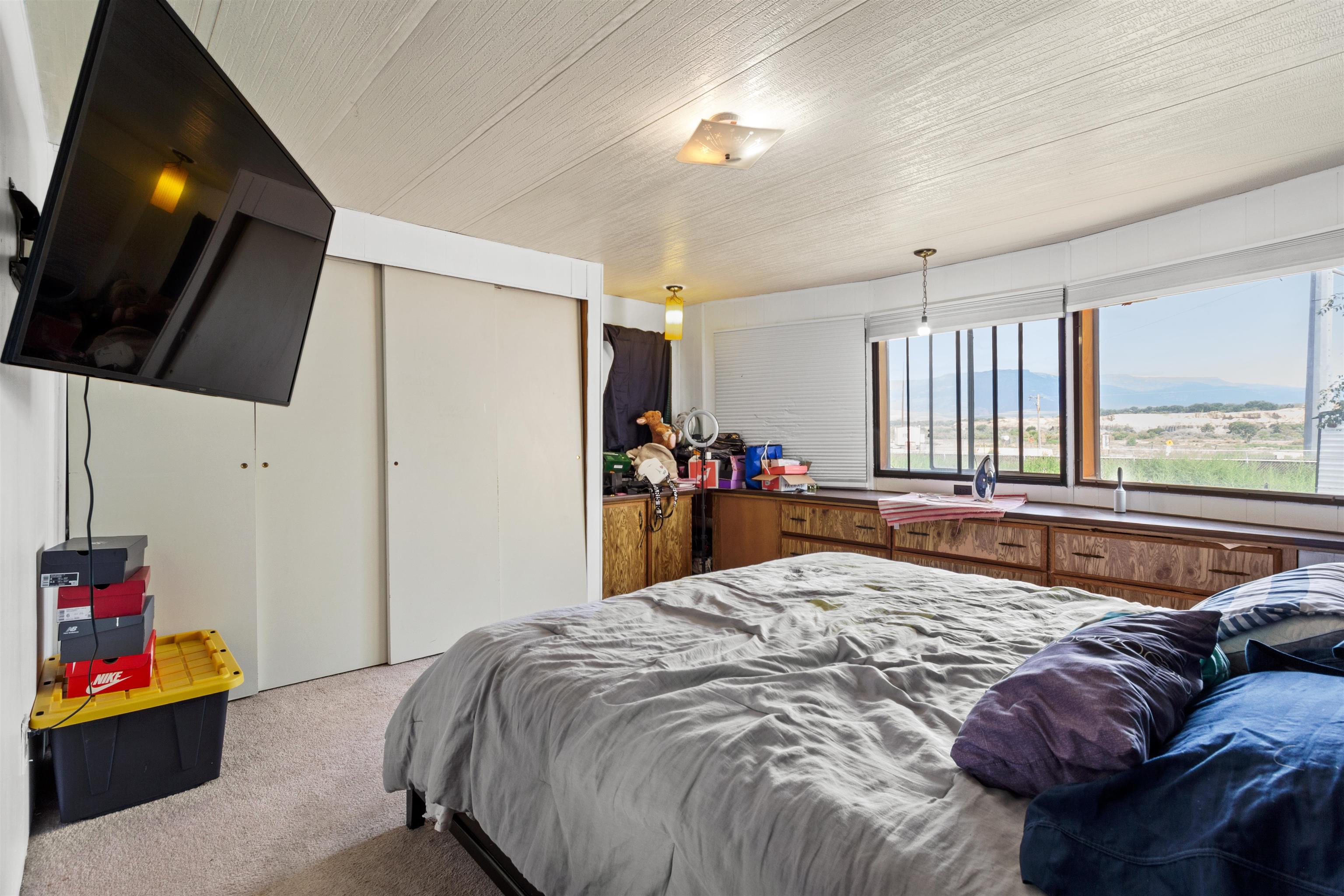 424 32 Road, Unit 262 Clifton, CO 81520 - Photo 14 of 16 a bed room with a bed window and a flat screen tv
