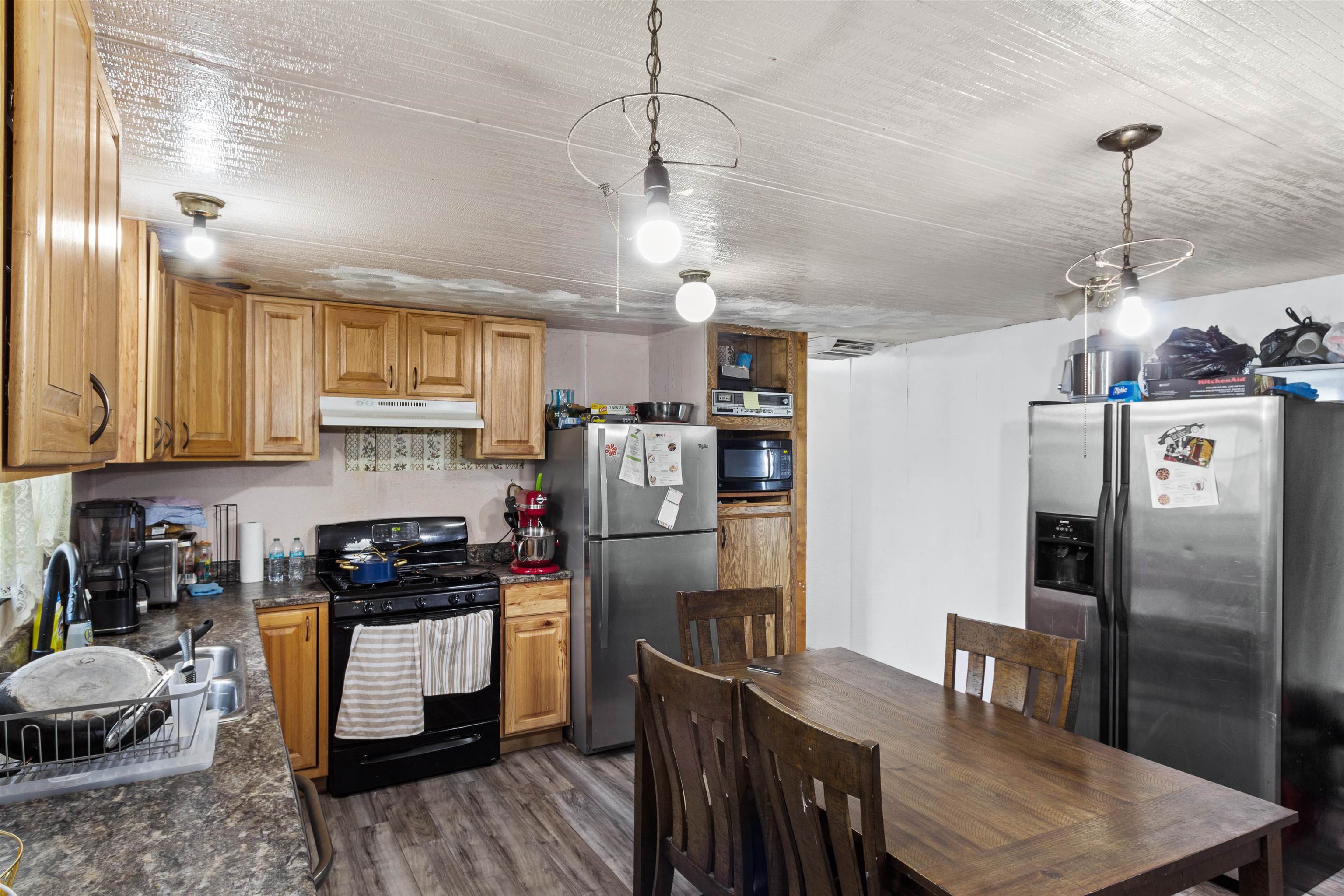 424 32 Road, Unit 262 Clifton, CO 81520 - Photo 7 of 16 a kitchen with stainless steel appliances granite countertop a refrigerator a sink dishwasher a stove a dining table and chairs with wooden floor