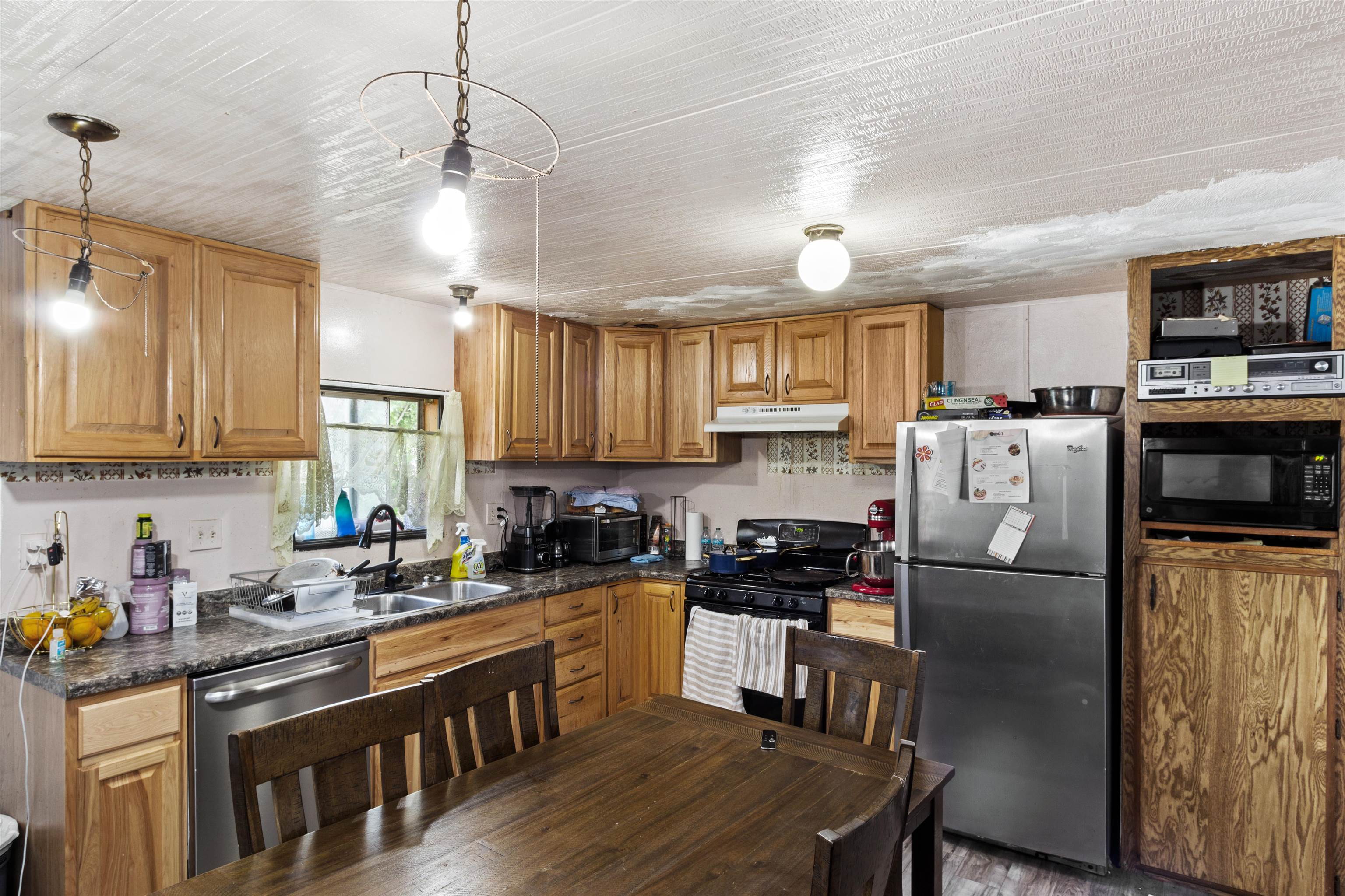 424 32 Road, Unit 262 Clifton, CO 81520 - Photo 8 of 16 a kitchen with stainless steel appliances granite countertop a refrigerator a sink dishwasher a stove and a dining table with wooden floor