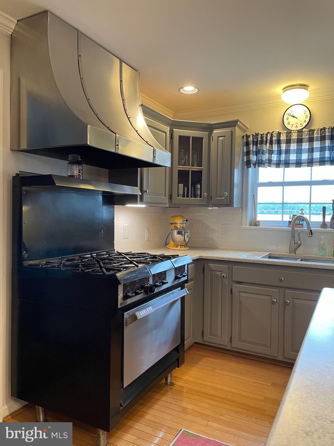 27950 Substation Road Denton, MD 21629 - Photo 14 of 80 Commercial Garland 6-burner gas range with hood