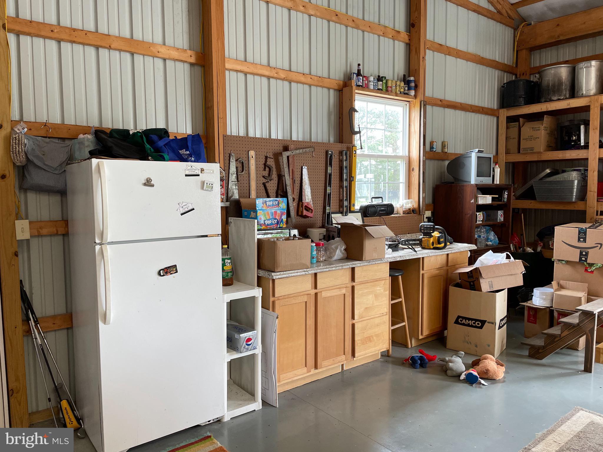 27950 Substation Road Denton, MD 21629 - Photo 66 of 80 Workshop/storage area in pole building.
