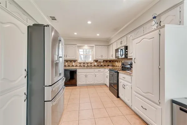 a kitchen with white cabinets and white appliances